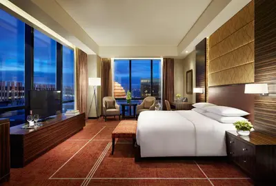 a hotel room with a bed and a large window at Hyatt Regency Manila City of Dreams in Manila