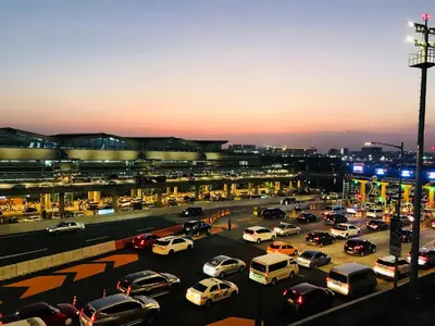 a parking lot filled with lots of cars at Condo 1 Palm Tree Across NAIA T3 in Manila
