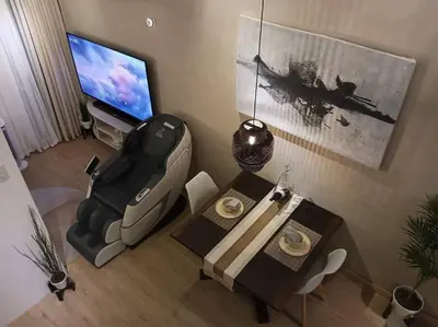 a living room with a television and a table and a chair at WHT Pod in Punta