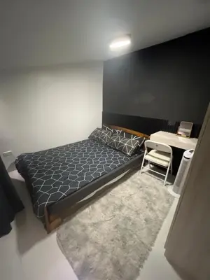 a bedroom with a bed and a table and a desk at WHT Pod in Punta