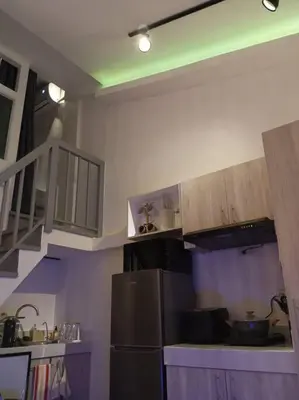 a kitchen with purple and white walls and a refrigerator at WHT Pod in Punta