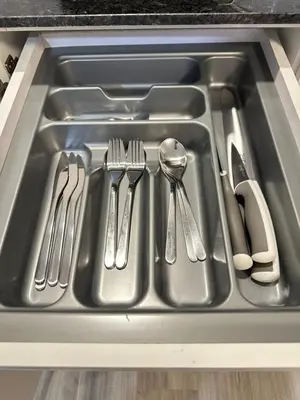 a sink with silver utensils in it at Zen Haven Staycation beside EK in Santa Rosa