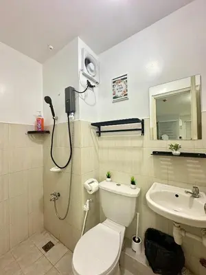 a bathroom with a shower and a toilet and a sink at Zen Haven Staycation beside EK in Santa Rosa