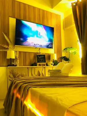 a bedroom with a flat screen tv on a wall at Not active listing in Manila