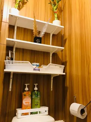 a bathroom with white shelves above a toilet at Not active listing in Manila
