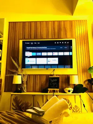 a living room with a television on a wooden wall at Not active listing in Manila