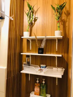 a bathroom with shelves with plants on a wooden wall at Not active listing in Manila
