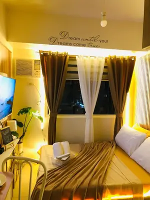 a bedroom with a bed and a window with curtains at Not active listing in Manila