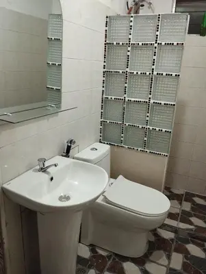 a bathroom with a white toilet and a sink at 15 Guest - Unit 1&2 House type and Studio type in Pasong Mannga
