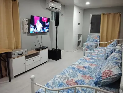 a hospital room with a bed and a flat screen tv at 15 Guest - Unit 1&2 House type and Studio type in Pasong Mannga