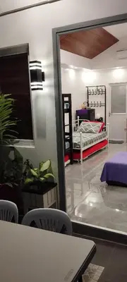 a room with a bed and a table and chairs at 15 Guest - Unit 1&2 House type and Studio type in Pasong Mannga