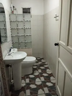 a bathroom with a toilet and a sink at 15 Guest - Unit 1&2 House type and Studio type in Pasong Mannga