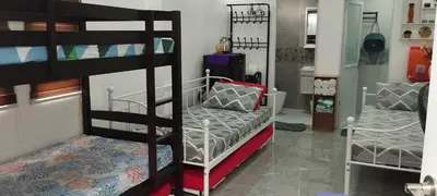 a room with two bunk beds and a couch at 15 Guest - Unit 1&2 House type and Studio type in Pasong Mannga