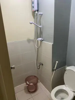 a bathroom with a shower stall with a toilet at Pierrecondotel in Manila
