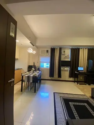 a kitchen and dining room with a table and chairs at A&G Condotel at 101 Newport Across NAIA T3 in Manila