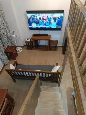 a living room with a flat screen tv on the wall at Happy Stays C - 300mbps - 65