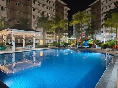 a large swimming pool at night with a playground at Happy Stays C - 300mbps - 65