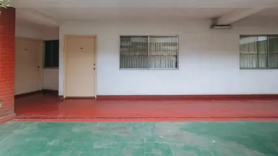 an empty room with two windows and a brick wall at RedDoorz at Broadway Court Apartelle II Quezon City in Manila