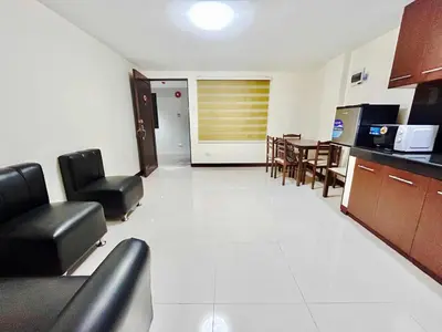 a living room with chairs and a dining room at OYO 1045 Rayjan Apartelle in Manila