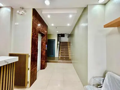 a hallway with a staircase in a house at OYO 1045 Rayjan Apartelle in Manila