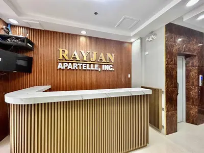 a lobby with a sign on a wall at OYO 1045 Rayjan Apartelle in Manila
