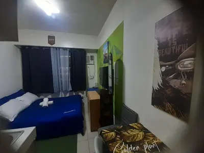 a small bedroom with a blue bed in a room at Nicecondotel in Manila