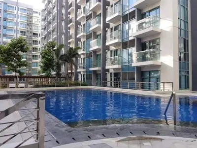 a large swimming pool in front of a building at RG condotel Near Naia Terminal 3 in Manila