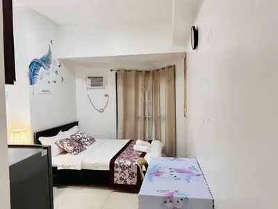 a small room with a bed and a table at Dreamy Sunset Bay in Manila