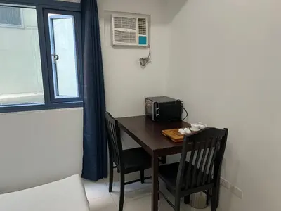 a small table with two chairs and a radio on it at Dreamy Sunset Bay in Manila