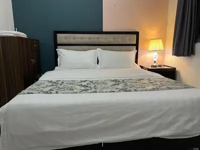a bedroom with a large bed with a white bedspread at Dreamy Sunset Bay in Manila