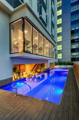 a swimming pool in the middle of a building at Cozy High Ceiling Studio @ Ortigas near Podium, Megamall in Manila