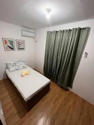 a small bedroom with a bed and a window at Modern Home and Stylish Design in Ibaba