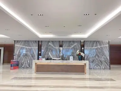 a lobby with a reception desk in a building at Manila Bay Retreat at Soleil Suite in Manila