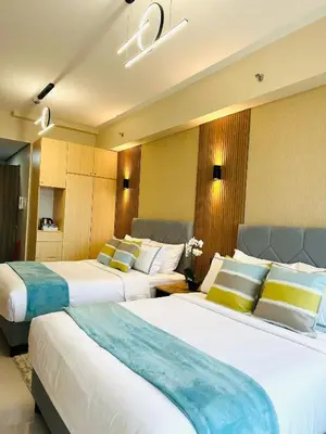 a hotel room with two beds in a room at Manila Bay Retreat at Soleil Suite in Manila