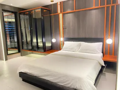 a bedroom with a large bed with white sheets at Malate Bayview Mansion 17A/B in Manila