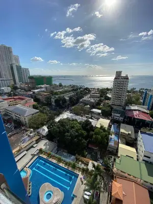 an aerial view of a city with a swimming pool at Malate Bayview Mansion 17A/B in Manila