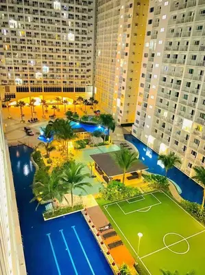 an aerial view of a tennis court in a city at Shore Residence D21 shortwalk MOA Balconypoolview in Manila