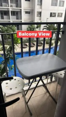 a table and a chair on a balcony with a balcony view at Shore Residence D21 shortwalk MOA Balconypoolview in Manila