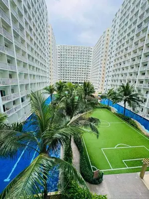 an aerial view of a resort with palm trees and buildings at Shore Residence D21 shortwalk MOA Balconypoolview in Manila
