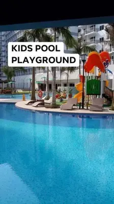 a large swimming pool with a kids pool play ground at SHELL RESIDENCE C23 Shortwalk MOA Balcony poolview in Manila