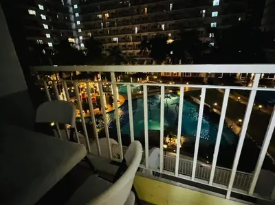 a view of a pool from a balcony at night at SHELL RESIDENCE C23 Shortwalk MOA Balcony poolview in Manila