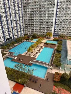 an overhead view of a large pool in a city at Makati SM Jazz Residence Staycation Condo with balcony in Manila