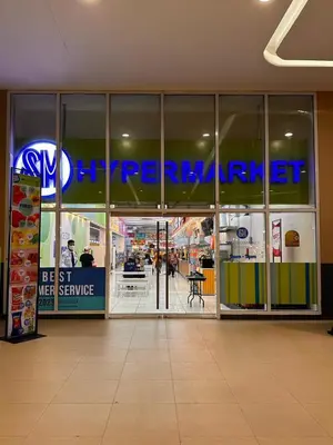 an entrance to a store with a sign on the window at Makati SM Jazz Residence Staycation Condo with balcony in Manila