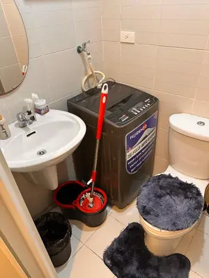 a bathroom with a mop and a toilet and a sink at Makati SM Jazz Residence Staycation Condo with balcony in Manila