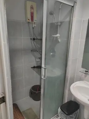 a shower with a glass door in a bathroom at Sea Residences-Reisha in Manila
