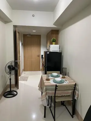 a small kitchen with a table and a refrigerator at Ella’s Condo@Shore3 T3 in Manila