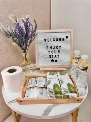 a table with a tray of toilet paper and a sign at Condo Unit near MOA, PICC, US Embassy and Airport in Manila