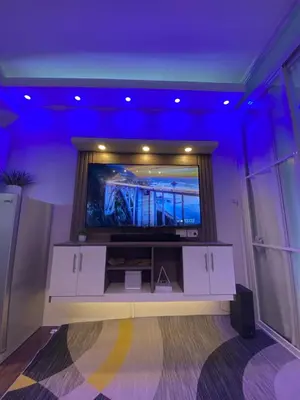 a room with a flat screen tv on a wall at Urbanview Oasis at Air Residences in Manila
