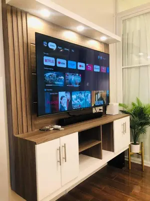 a large flat screen tv sitting on a entertainment center at Urbanview Oasis at Air Residences in Manila
