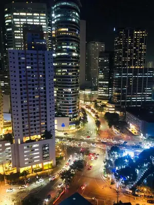 a city skyline at night with traffic on a street at Urbanview Oasis at Air Residences in Manila
